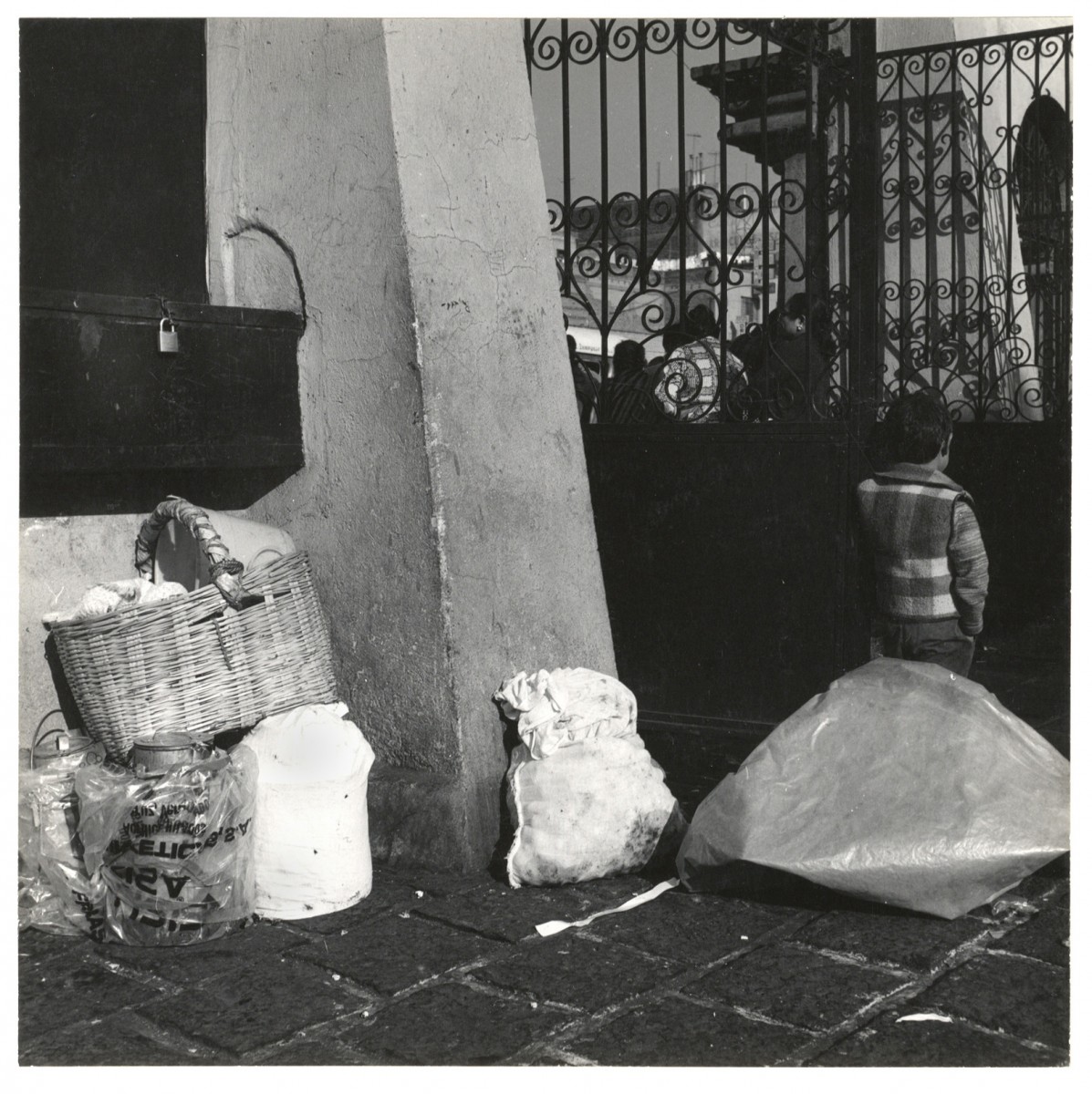 Untitled (bags, boy, fence)